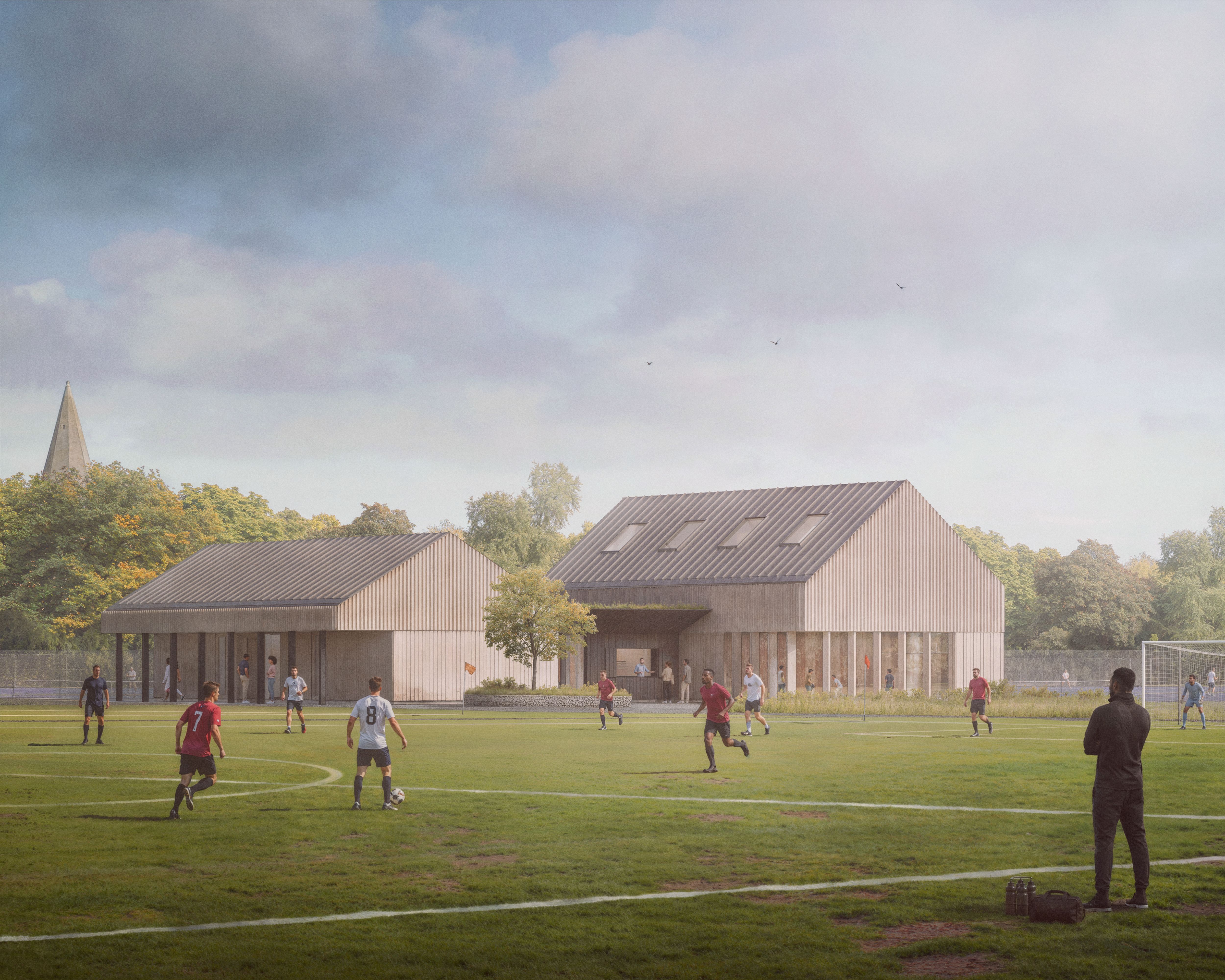 Visualisation of Woodlands, showing a timber-clad sports pavilion beside a football pitch, with players on the field and a church spire beyond